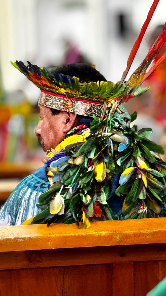 A Kamentsá elder in feathered ceremonial headdress during Bëtsknaté, Sibundoy Valley, Colombia