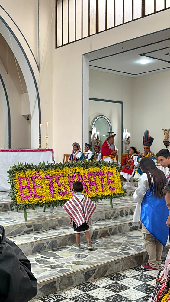 Floral lettering spelling Bëtsknaté before the altar during the Carnival of Forgiveness, Sibundoy Valley, Colombia