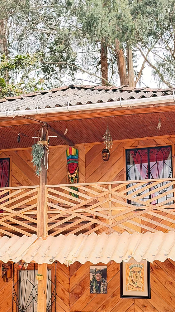 Timber guest lodging with carved balcony at Shanayoy Healing Center, Kamentsá Reservation, Colombia