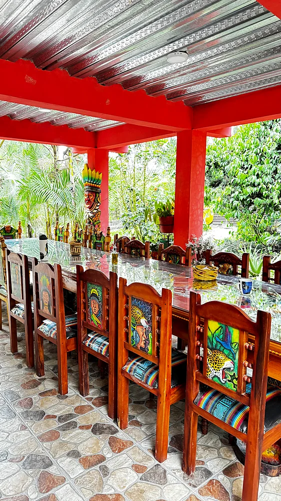 Long shared dining table under an open-sided roof at Shanayoy, Sibundoy Valley, Colombia